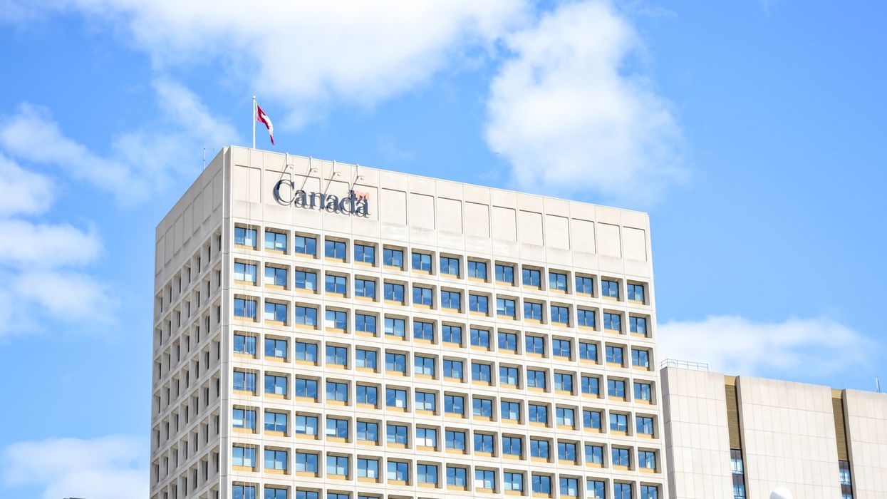 exterior of government building with canada logo and canadian flag