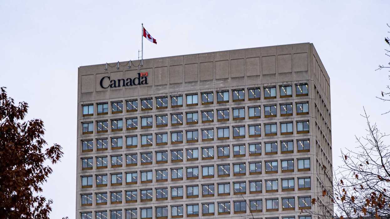 exterior of government of canada building with canada logo and canadian flag
