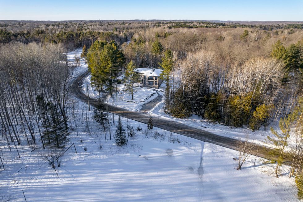Exterior of the home overlooking the pond.