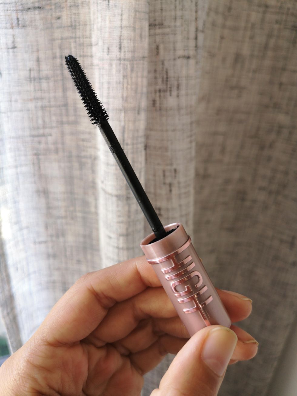 Brittany holding the maybelline lash sensational sky high mascara