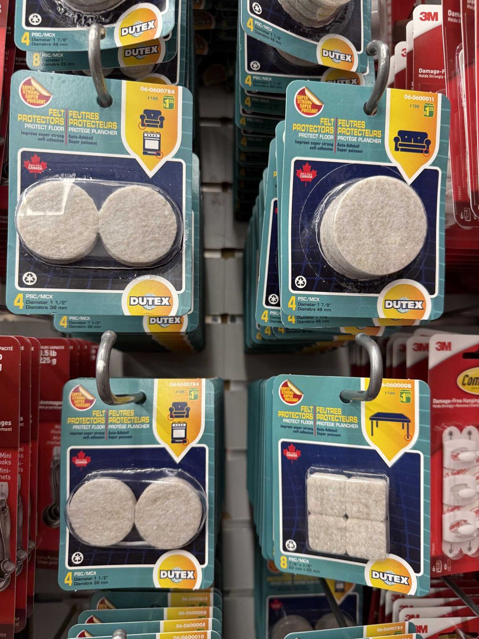 Felt protectors in different sizes and packaging hanging on a store shelf.