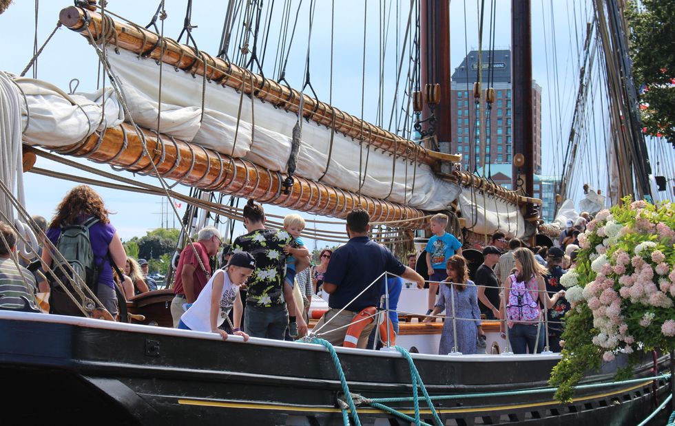 Festival guests touring the deck of a Tall Ship in Brockville, Ontario.