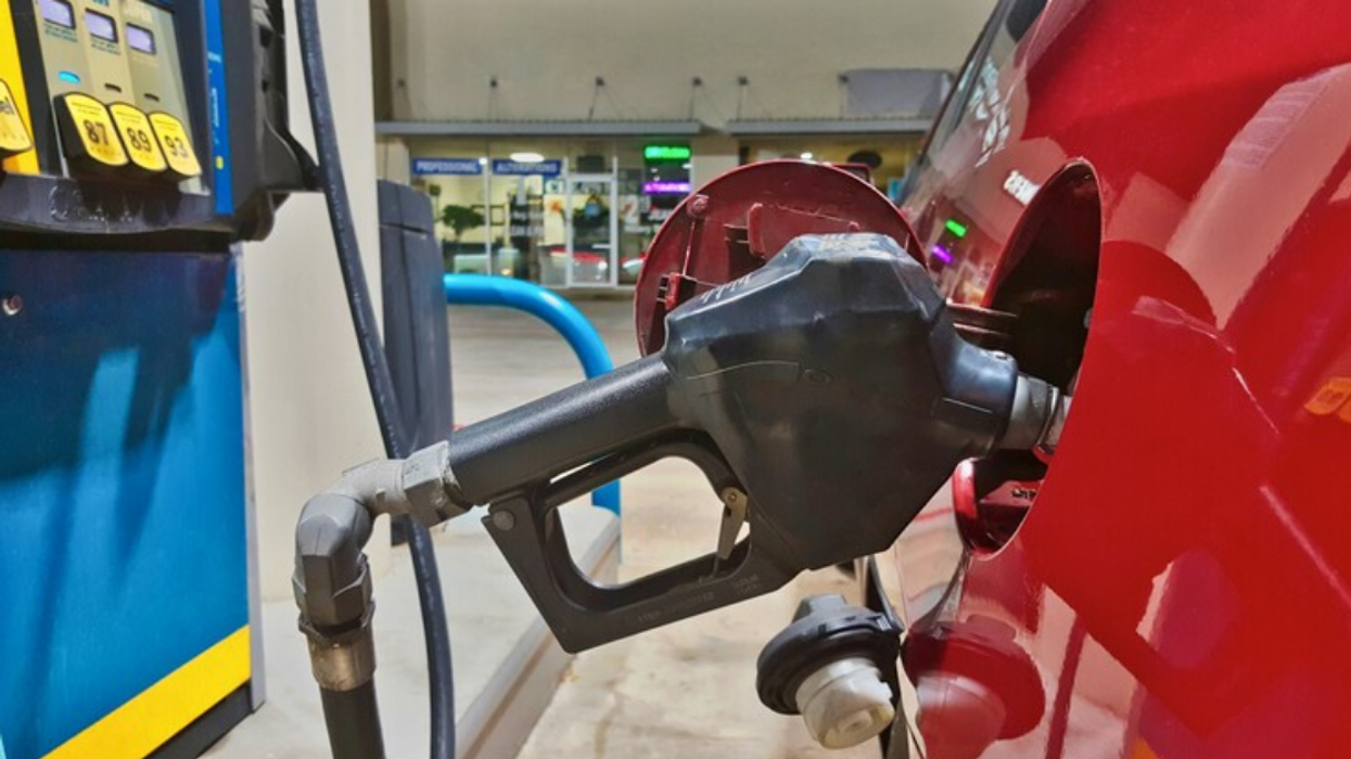 Filling up a car at a gas station.