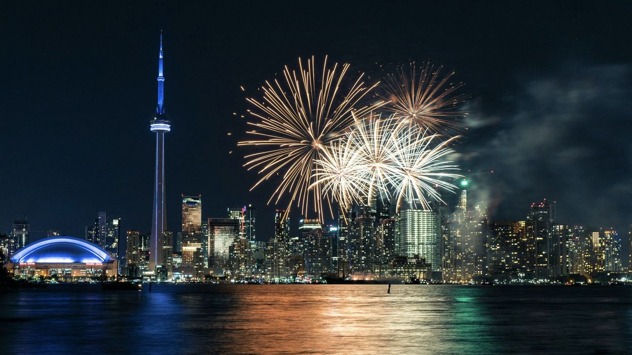 Fireworks over Lake Ontario with the Toronto skyline in the background.