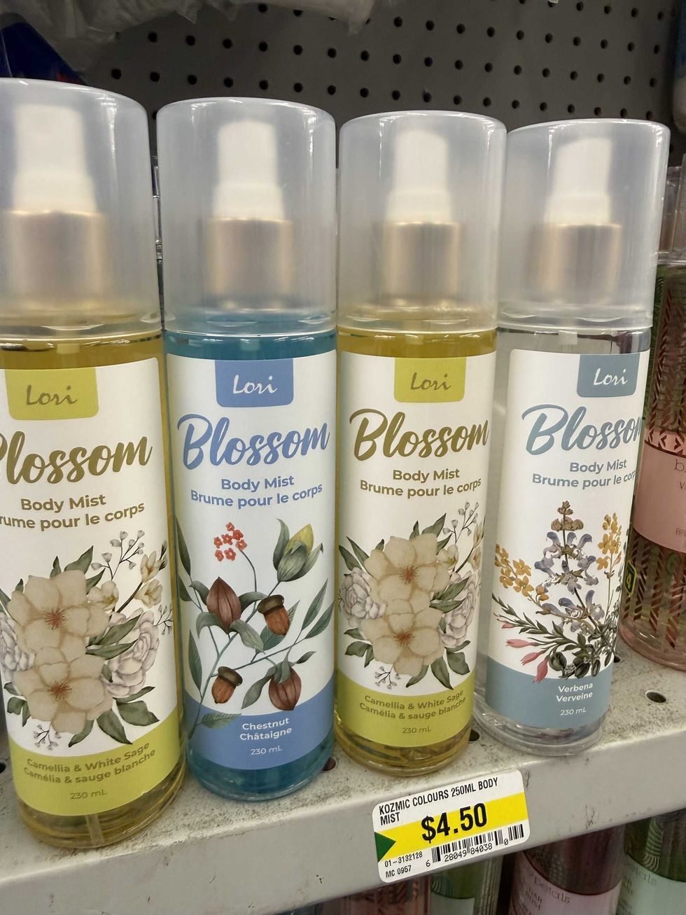 Four bottles with pictures of flowers on them and labels that read body mist.