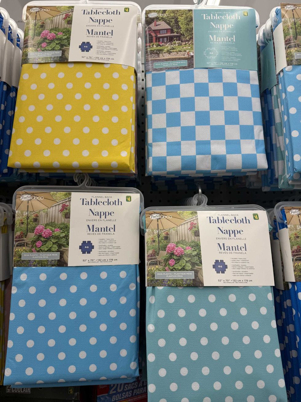Four tablecloths in yellow and blue with checkered and polka dot designs.