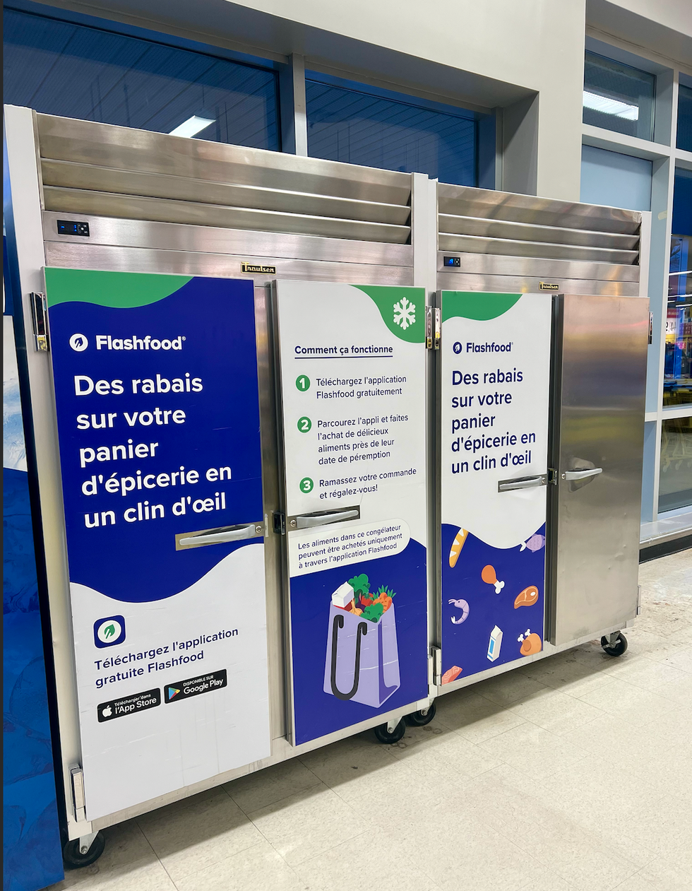 Frigos install\u00e9s dans un magasin Maxi arborant des affiches concernant le fonctionnement de FlashFood.