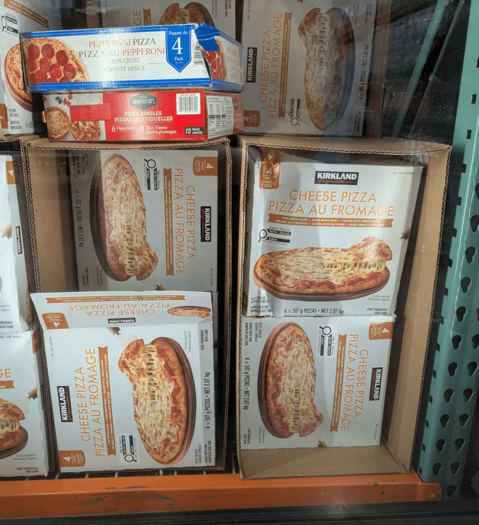 Frozen cheese and pepperoni pizzas in a store display.