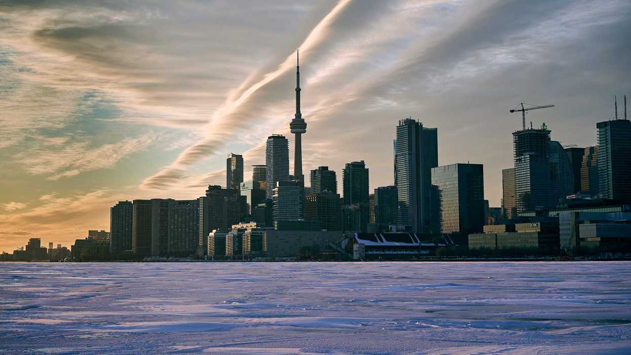 frozen lake ontario with toronto skyline in the background