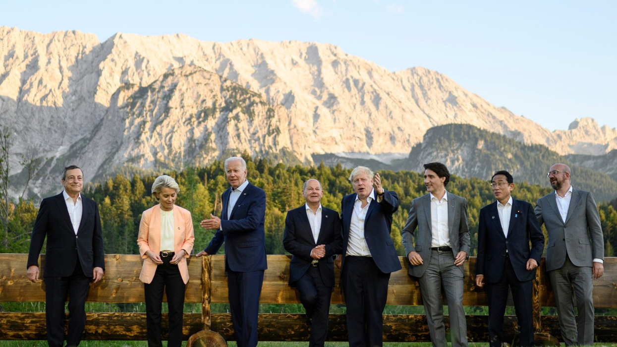 G7 leaders pose for a photo in front of a mountain in Germany.