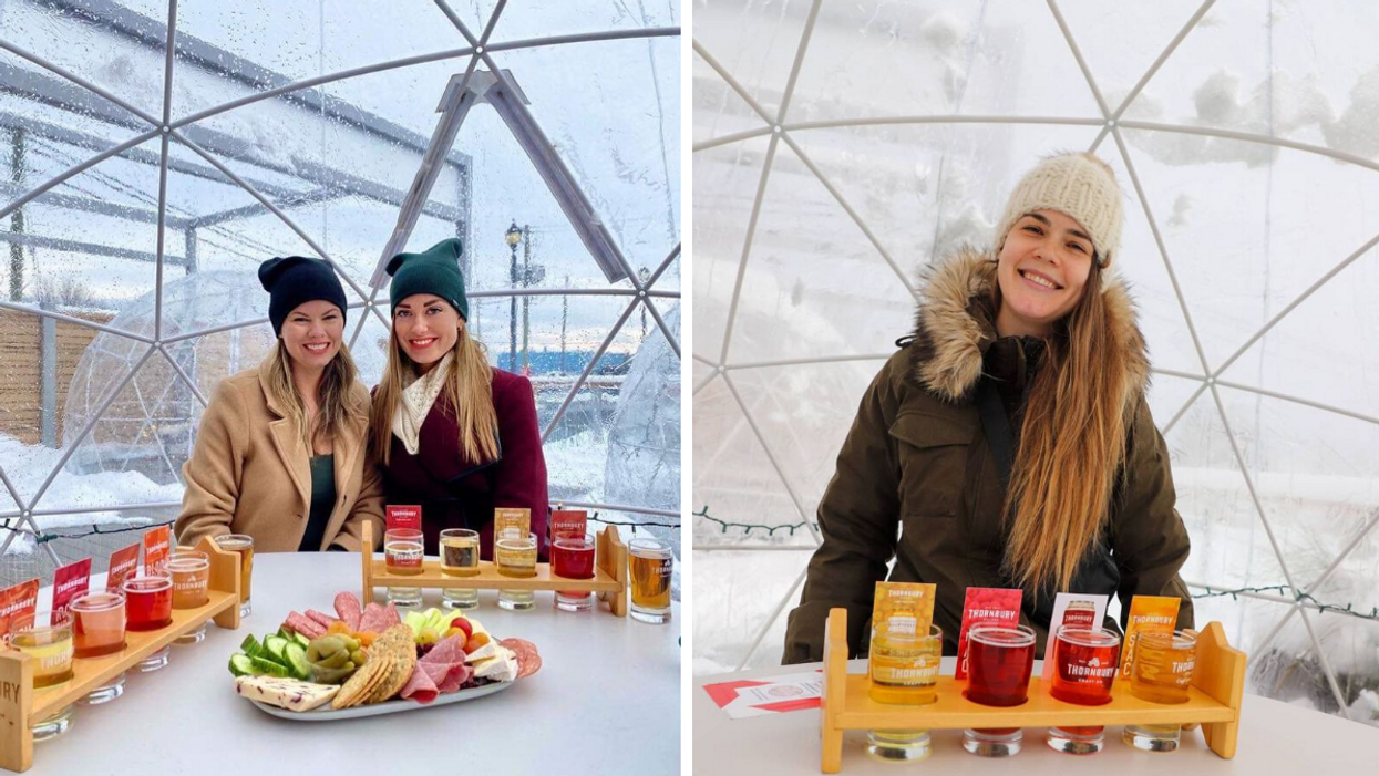 Girls drinking flights of cider in a heated snow globe on a patio.