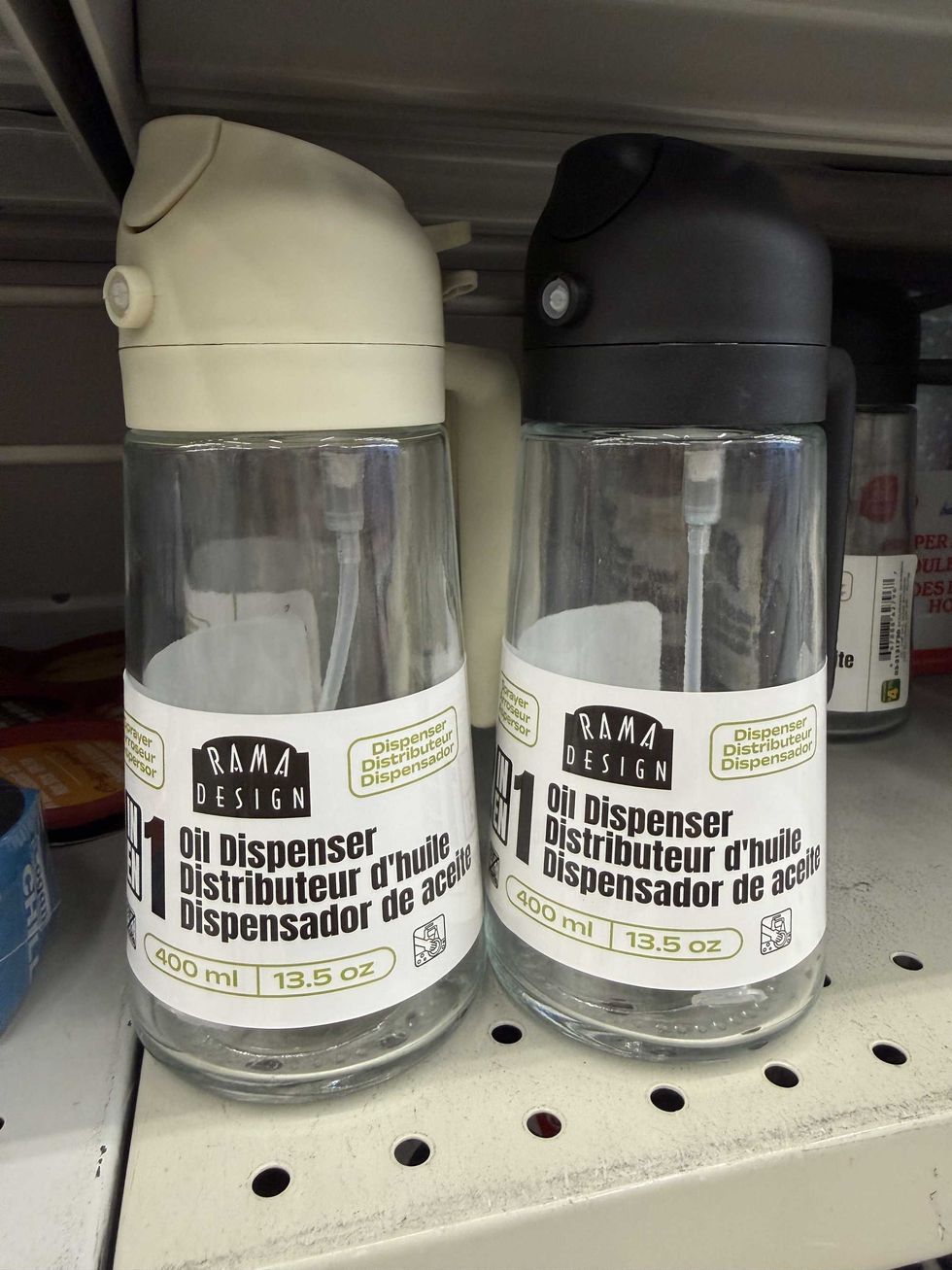 Glass bottles with beige and black lids and labels that say oil dispenser on them.