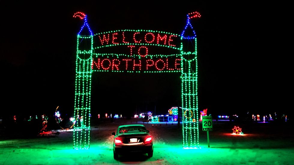 Glowing North Pole sign on a holiday trail.