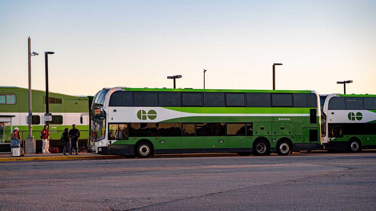 go transit buses and train at a station in ontario