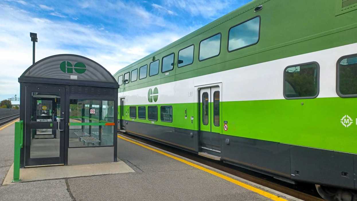 go transit train on tracks beside platform at go station in toronto