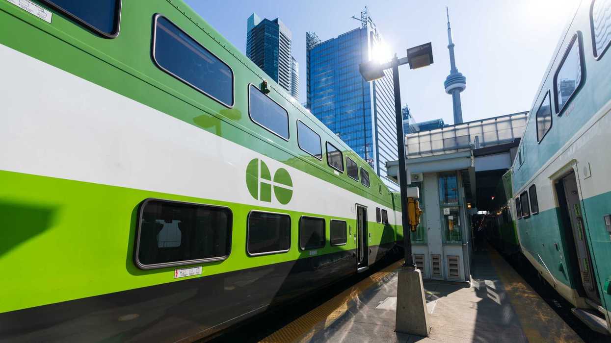 go transit trains on tracks at union station in toronto with cn tower in background