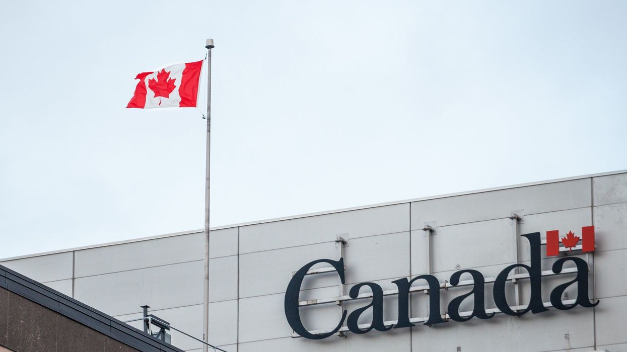 government building with canada logo and canadian flag