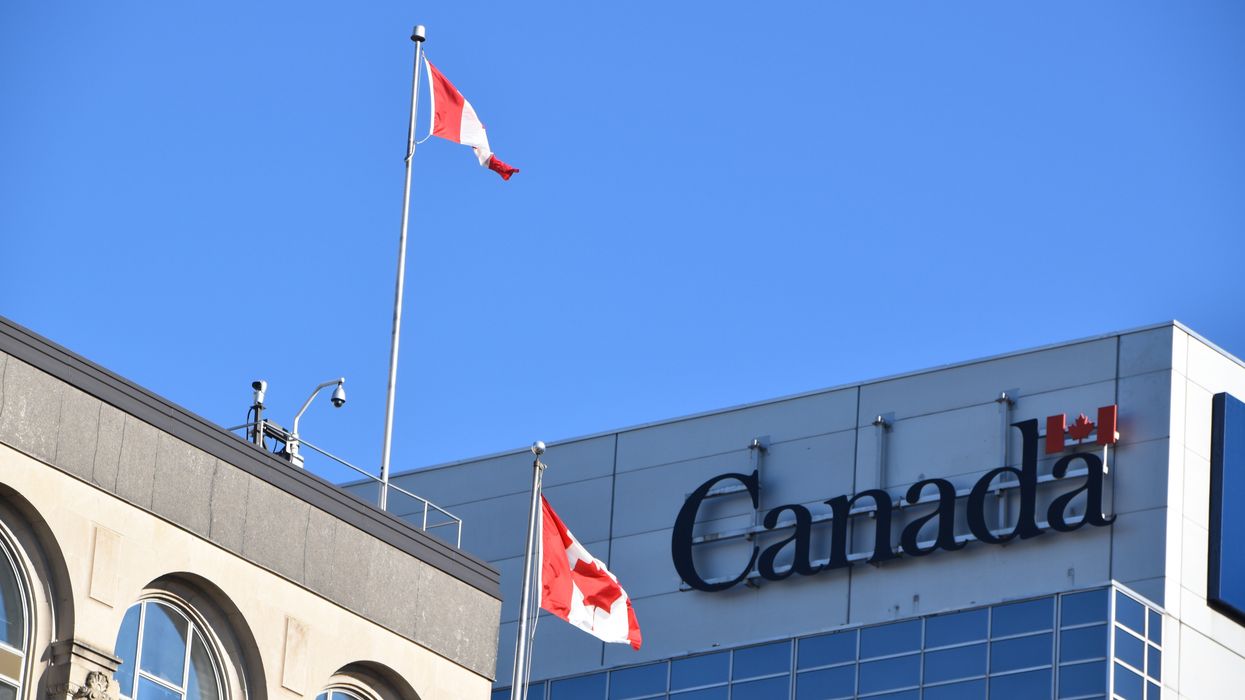 government of canada bulding with cnadian flags