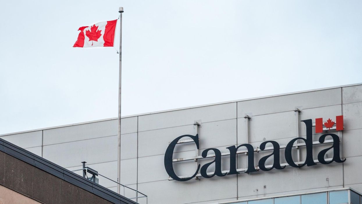Government of Canada sign with a Canadian flag on a building.