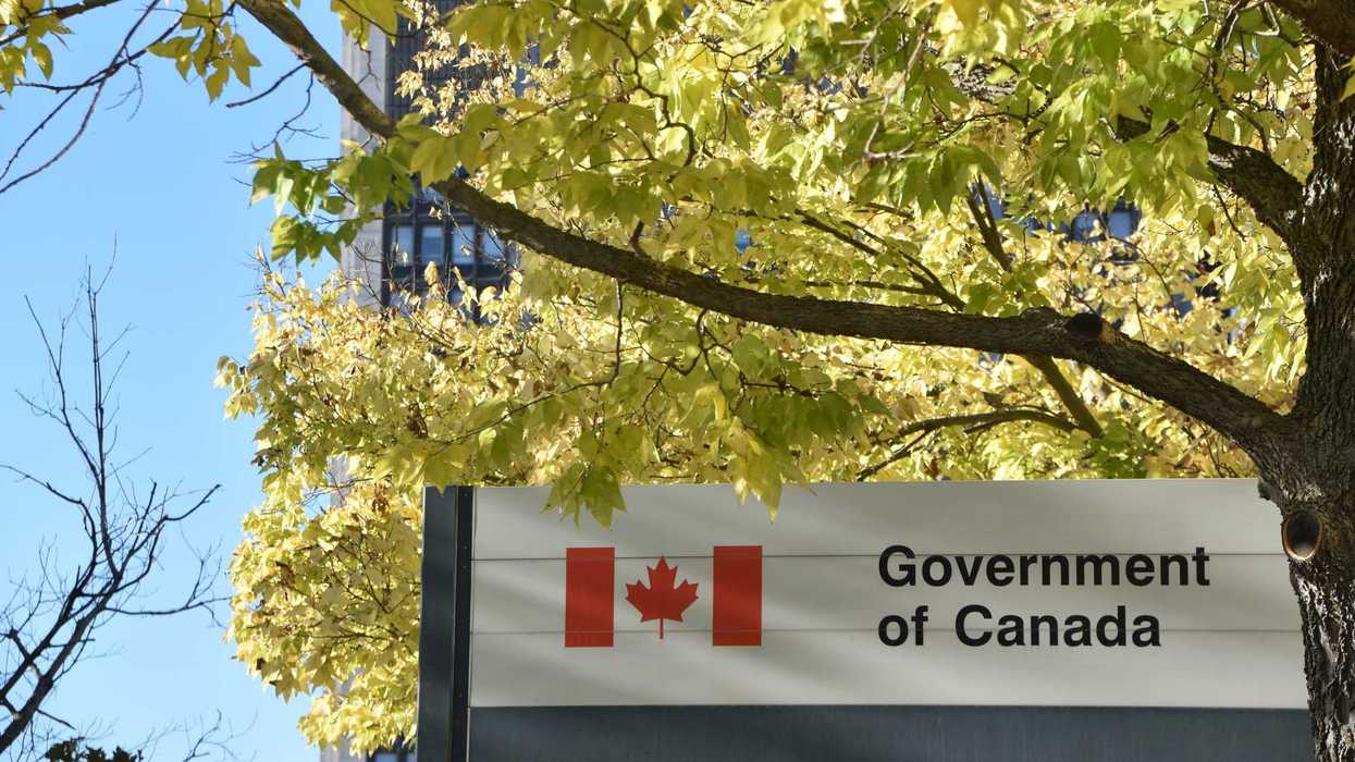 government of canada sign with canada flag logo outside of building in ottawa