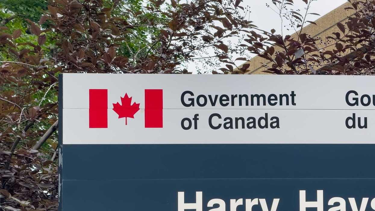 government of canada sign with canadian flag logo at building in alberta