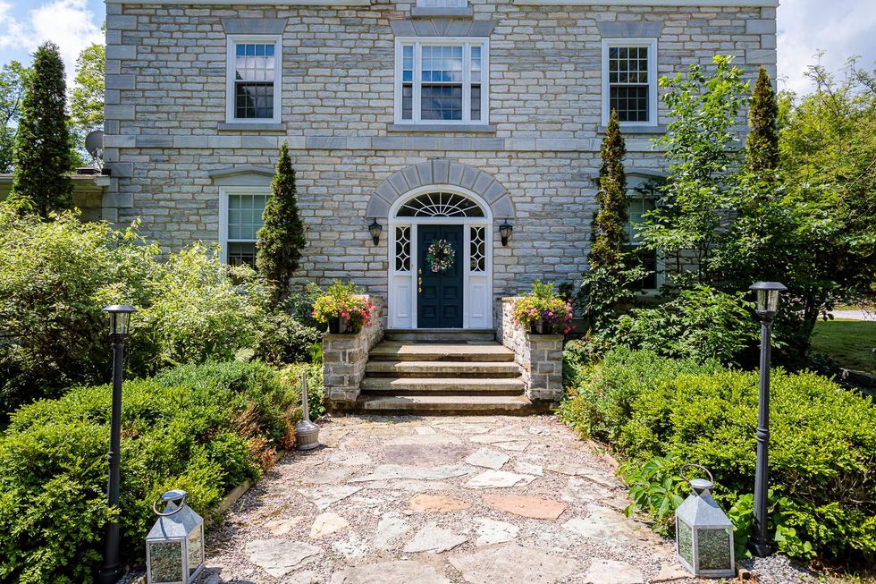 Grand front path to historic stone mansion for sale.