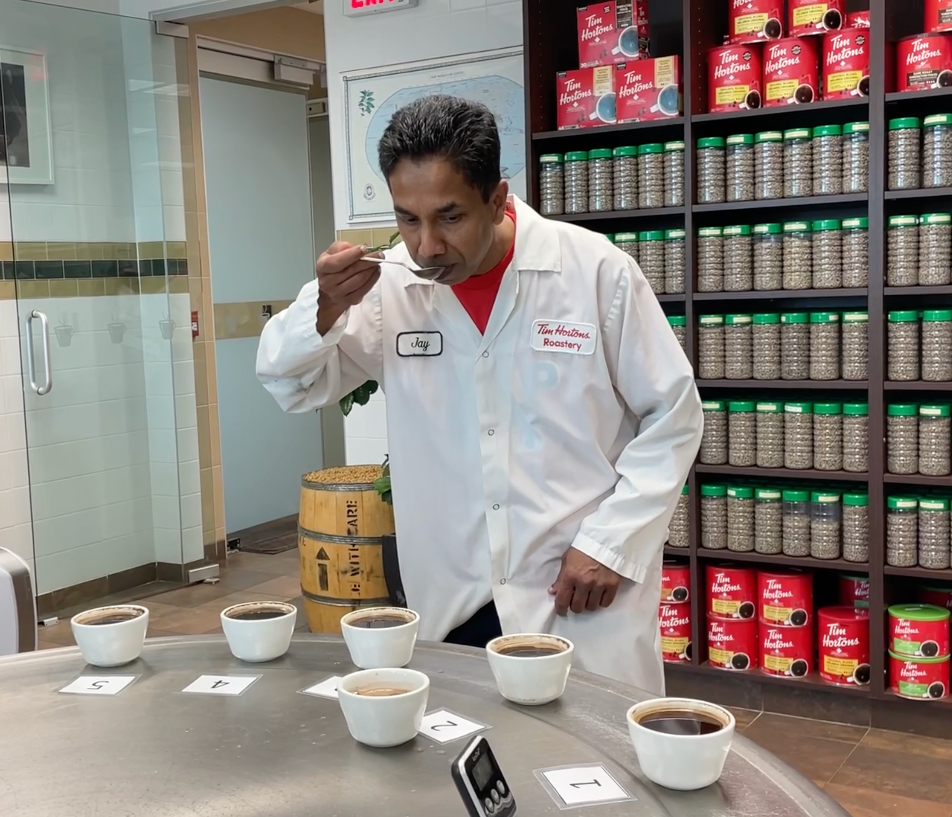 Green Coffee Quality Manger Jay Pathirana cupping coffee.