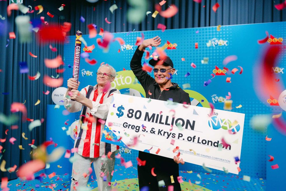 Greg S. and Krys P. holding $80 million cheque and confetti
