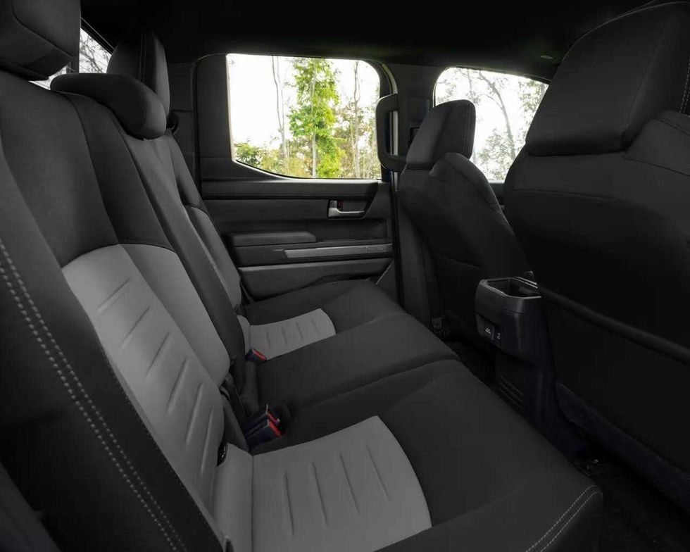 Grey rear seats in the back of the double cab of a Toyota Tacoma.