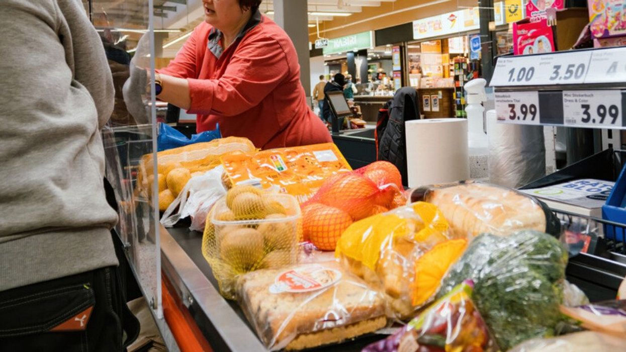 Groceries on the conveyor belt at a grocery store checkout counter.