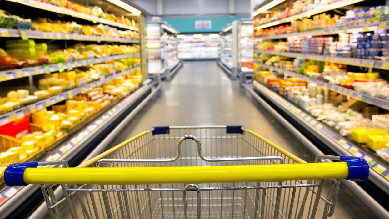 Grocery cart in a supermarket aisle (illustrative).