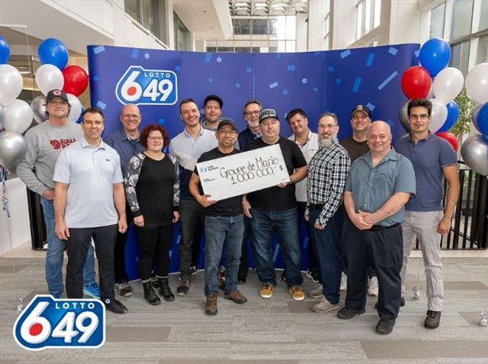 group of 14 lotto 6/49 winners in montreal with a $1 million cheque