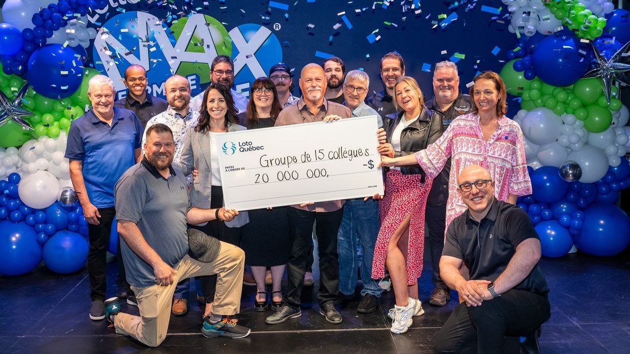 group of lotto max winners with a $20 million cheque