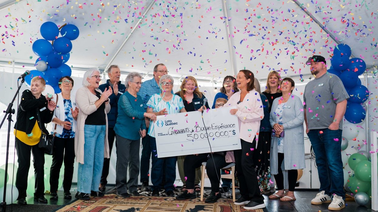group of lotto max winners with a $50 million cheque