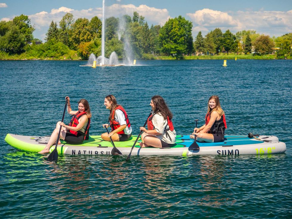 Group paddleboarding on a lake.