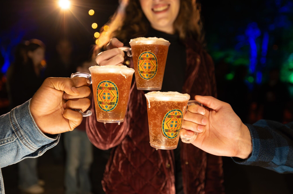 Guests enjoy a themed village at the end of the illuminated trail.