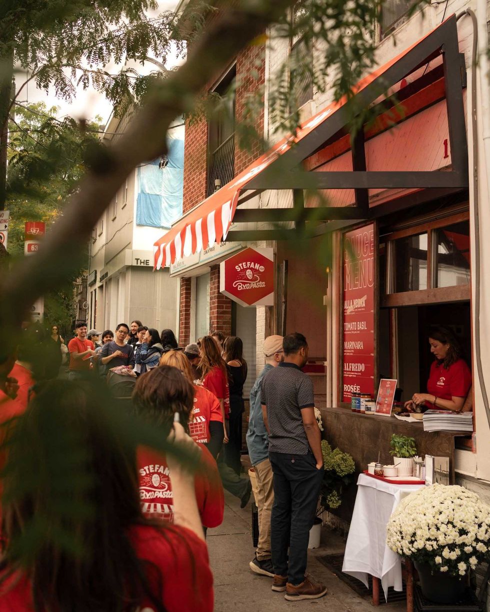 Guests lining up at the window of Stefano's BYOPasta restaurant in Toronto.