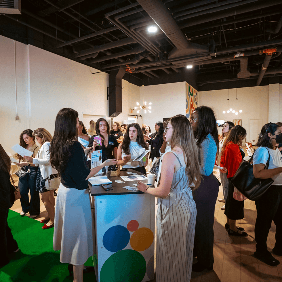 Guests network and learn more about investing at an educational event.