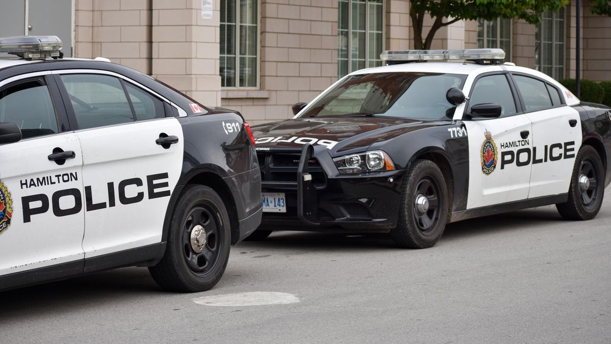 Hamilton police cars parked on a street.