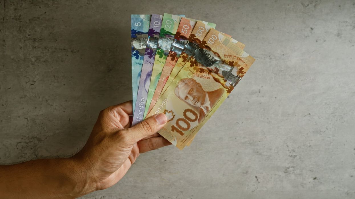 Hand holding Canadian money.