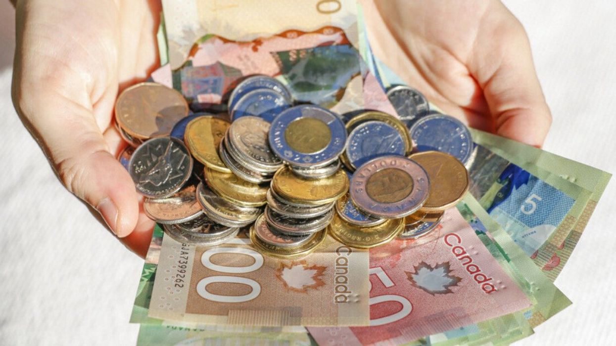 Hands holding Canadian cash and bills