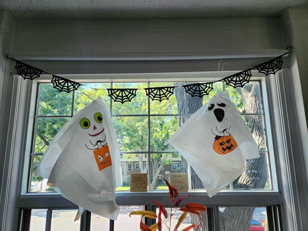 Hanging ghost decorations and spiderweb bunting from Dollarama.