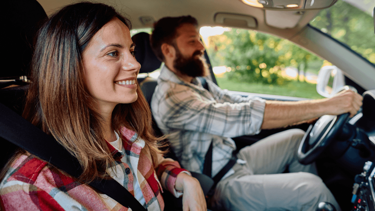 Happy couple driving car