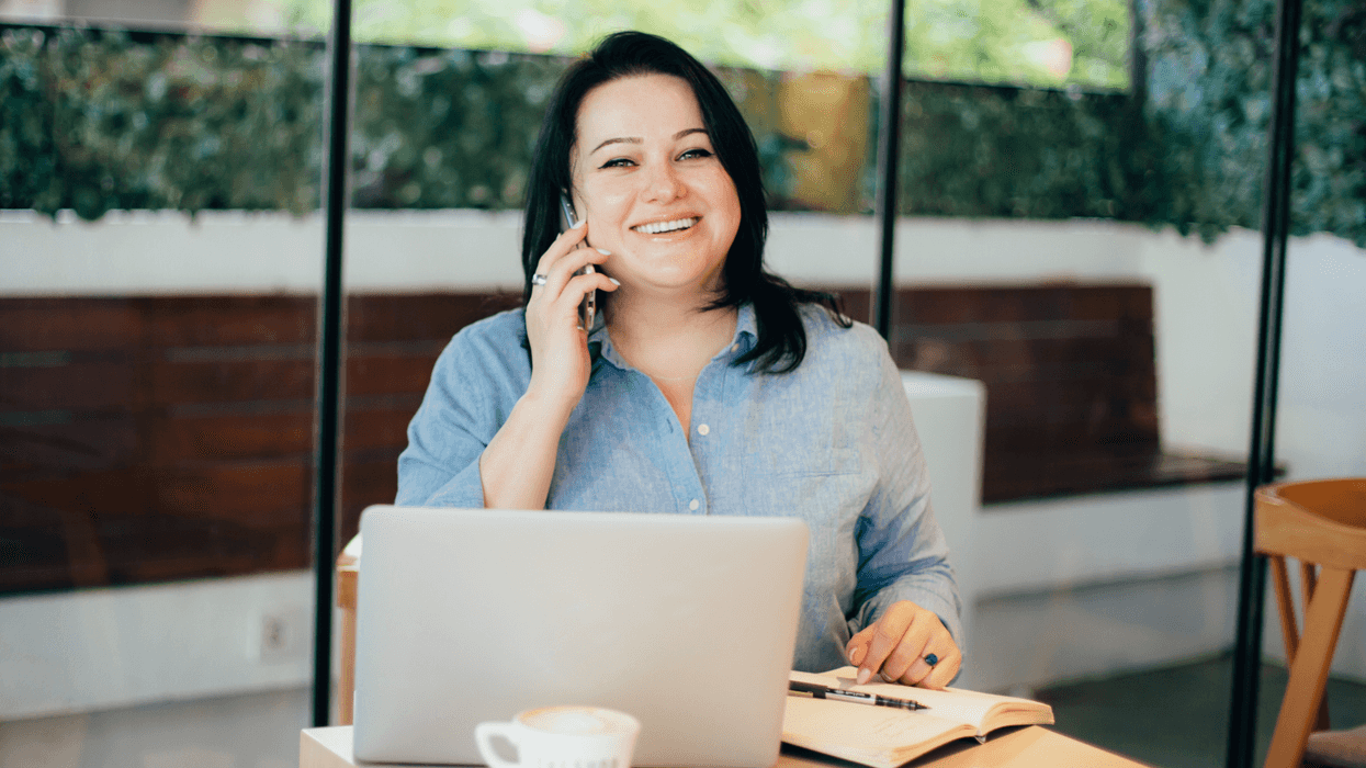 Happy woman on phone in a modern office space