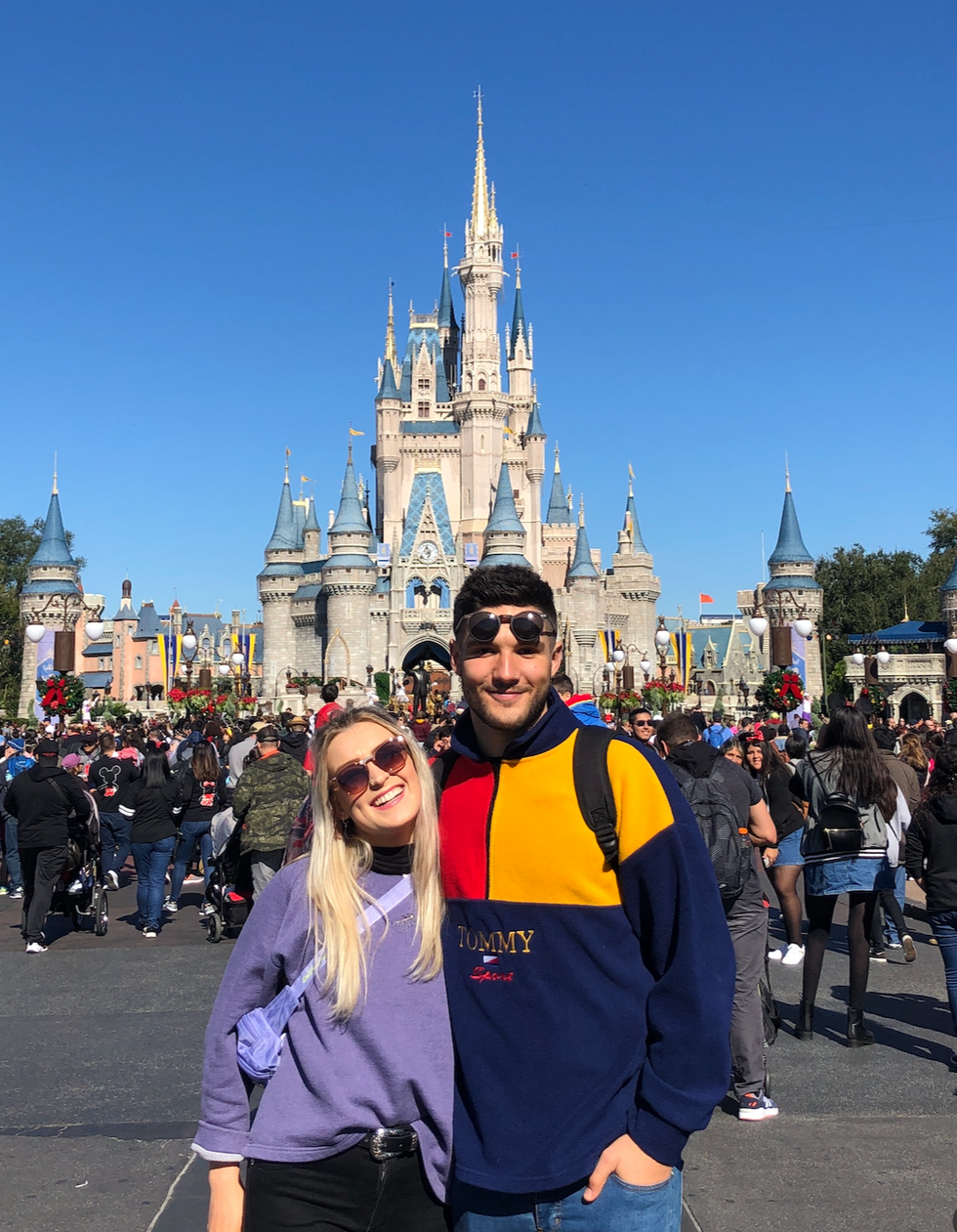 Helena and Amos pose outside of the castle in Magic Kingdom.