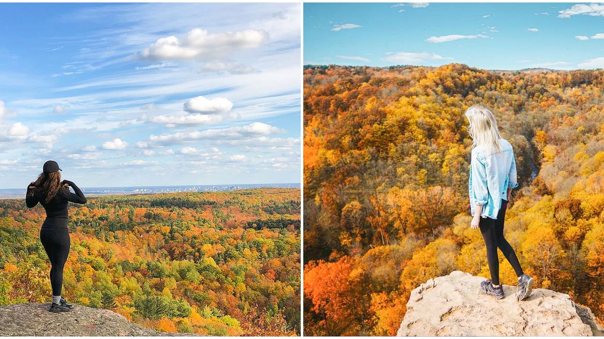 Hikers looking out at fall foliage.