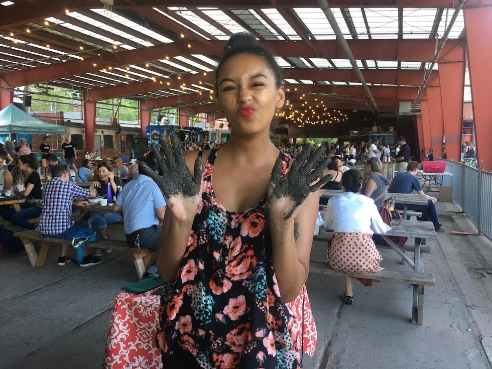 Hillary showing her hands full of dirt at Evergreen Brick Works.