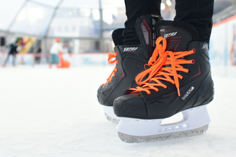 Hockey skates are seen on the ice at a rink.