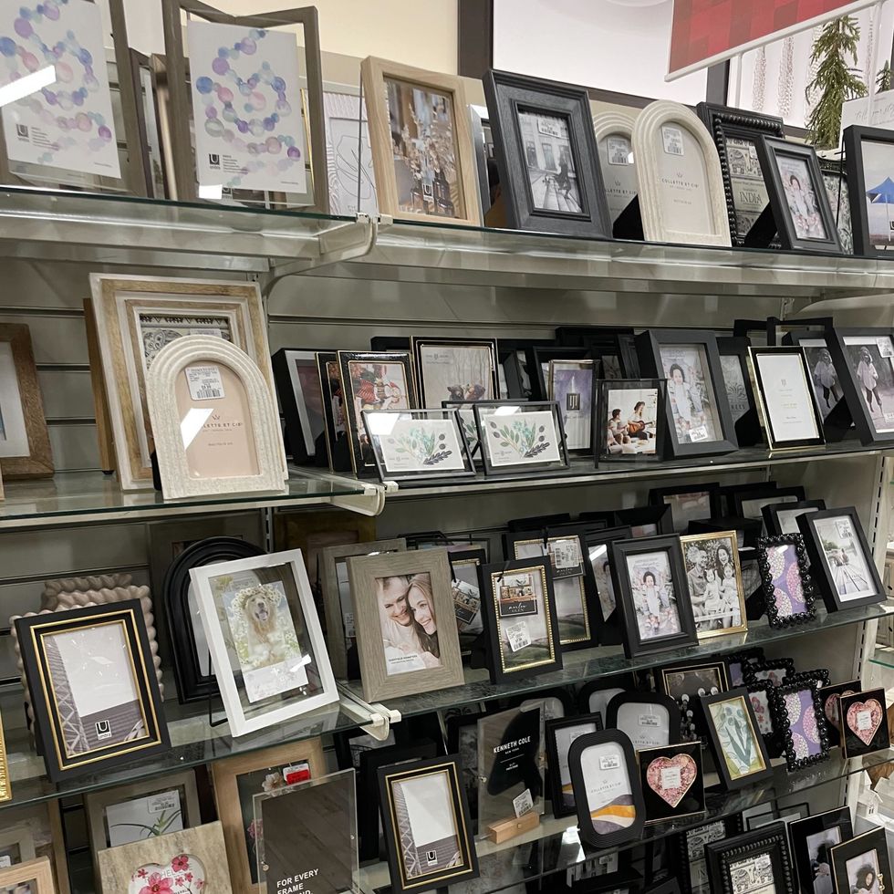 HomeSense picture frames on a shelf in a store.