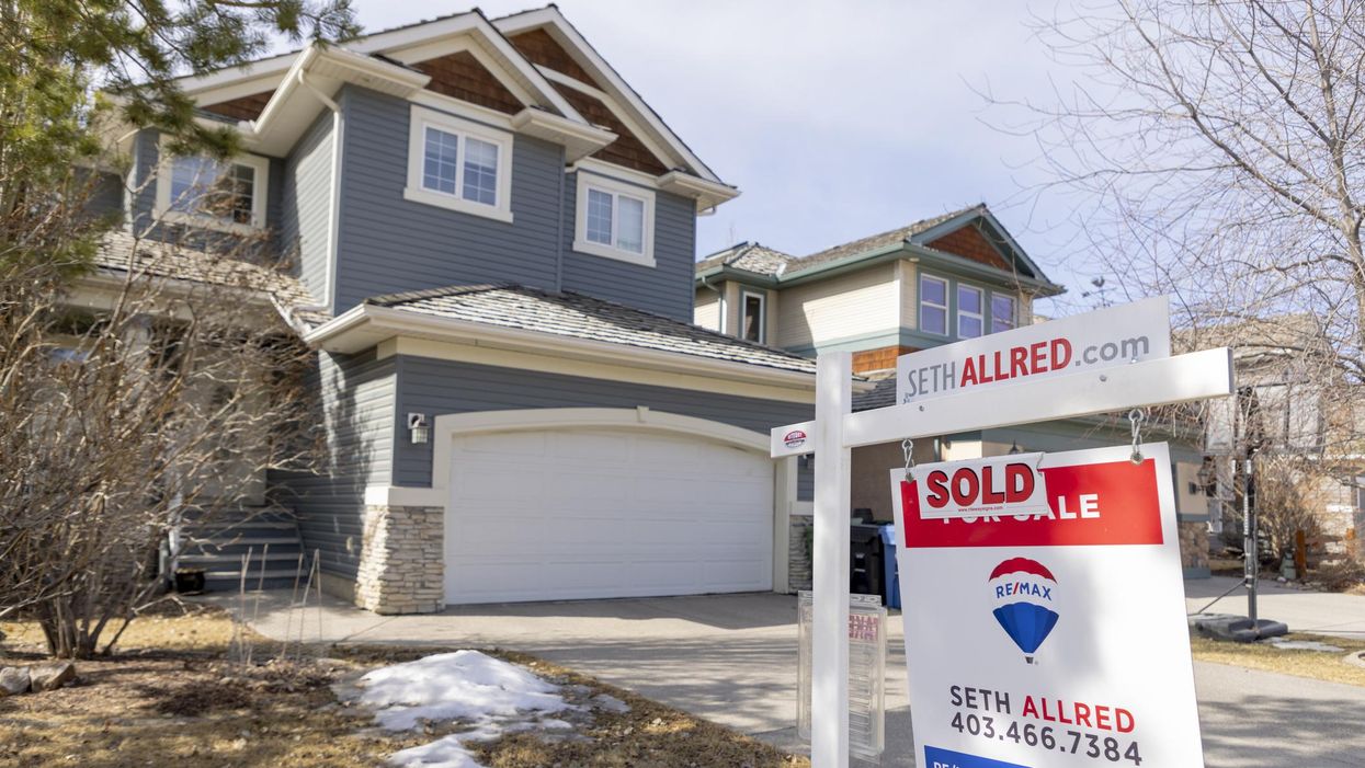 House in Alberta with a sign that it has been sold.